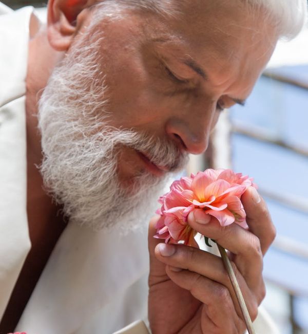 Close-up of a senior person's hands in a meditative pose.